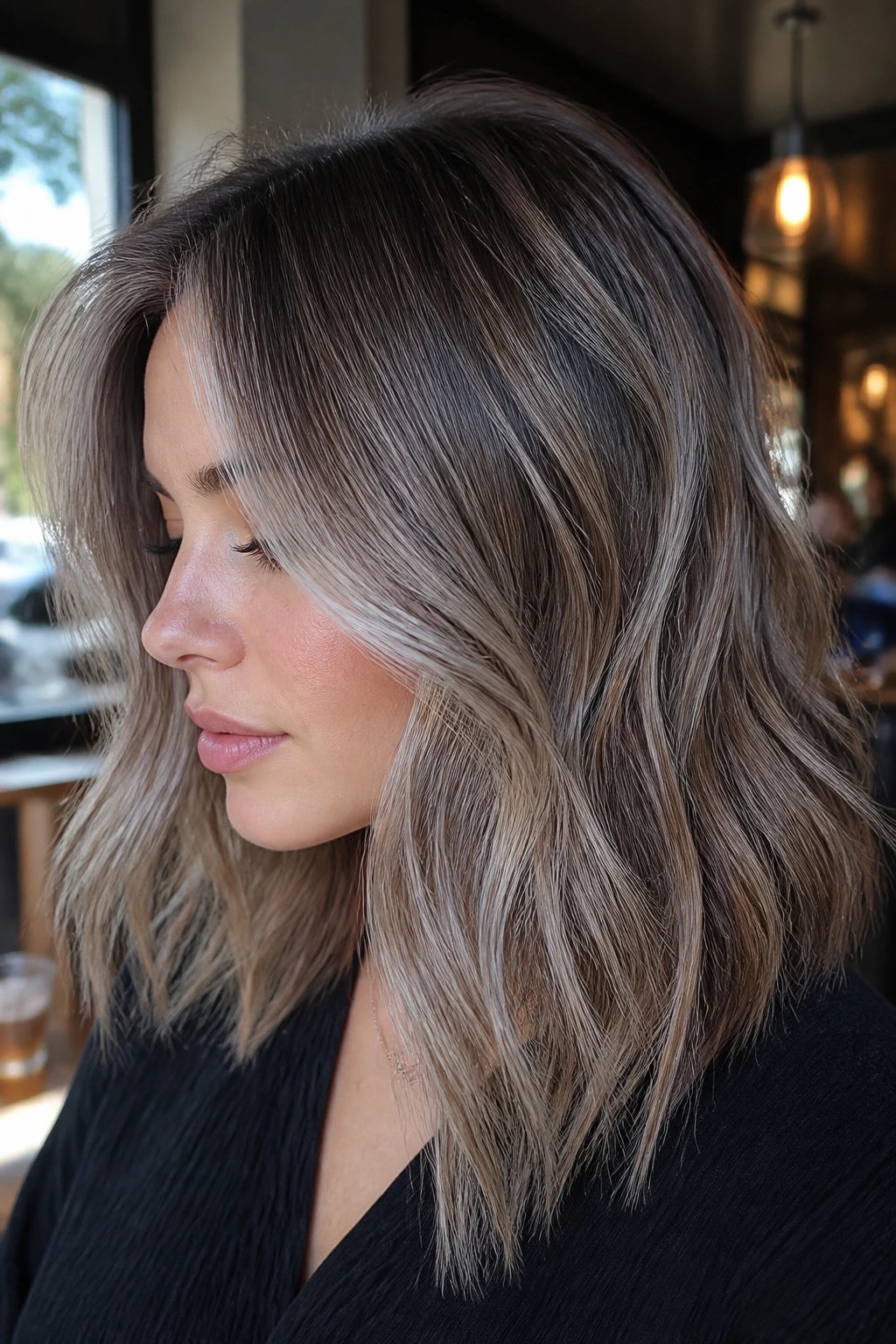 Real woman with cool bronde hair and gray veils framing the face