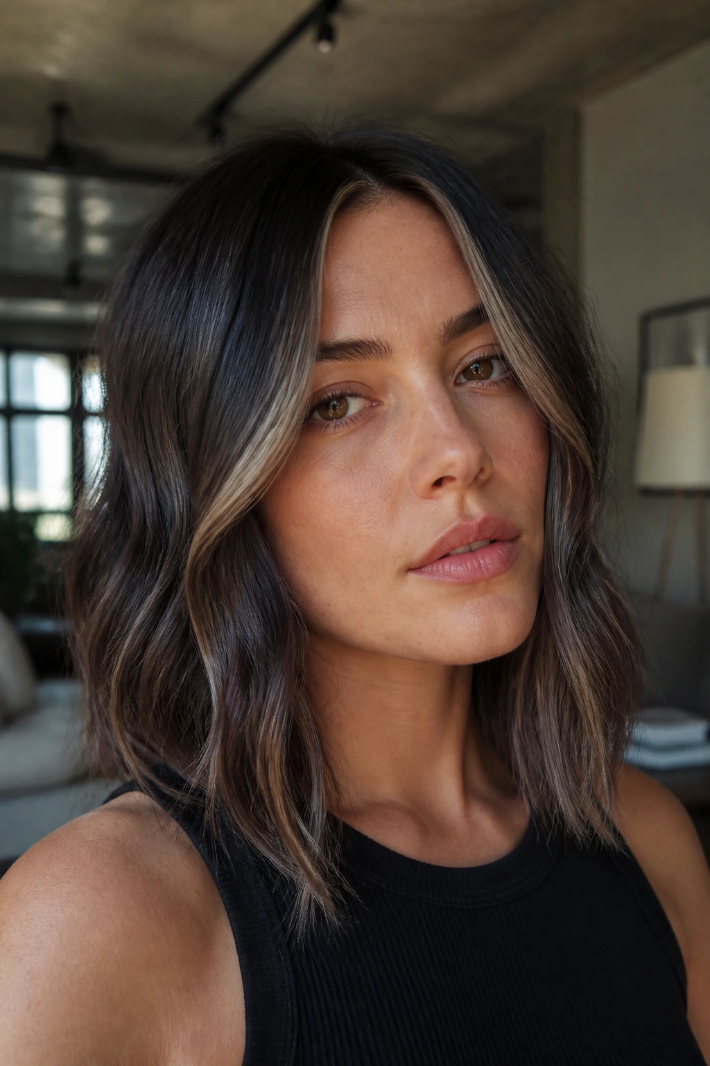 Close-up portrait of a real woman with cool-toned brunette hair featuring espresso gloss and ash tones.