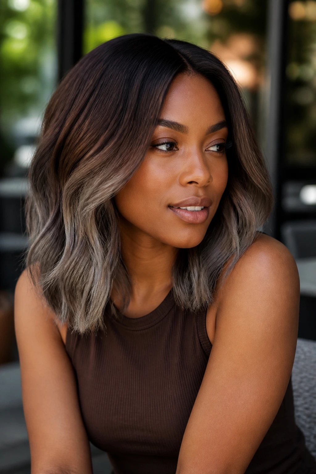 Portrait of deep skin model with cool cocoa ombré hair