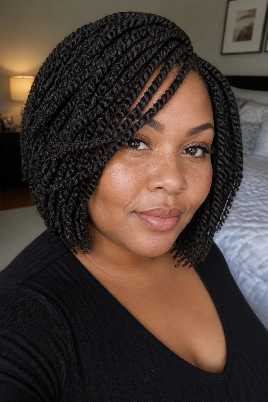 Close-up portrait of a real woman with crochet bob hairstyle in a cozy bedroom