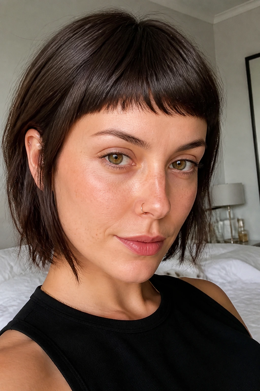 Close-up of a real woman with a cropped crescent fringe under the brow line