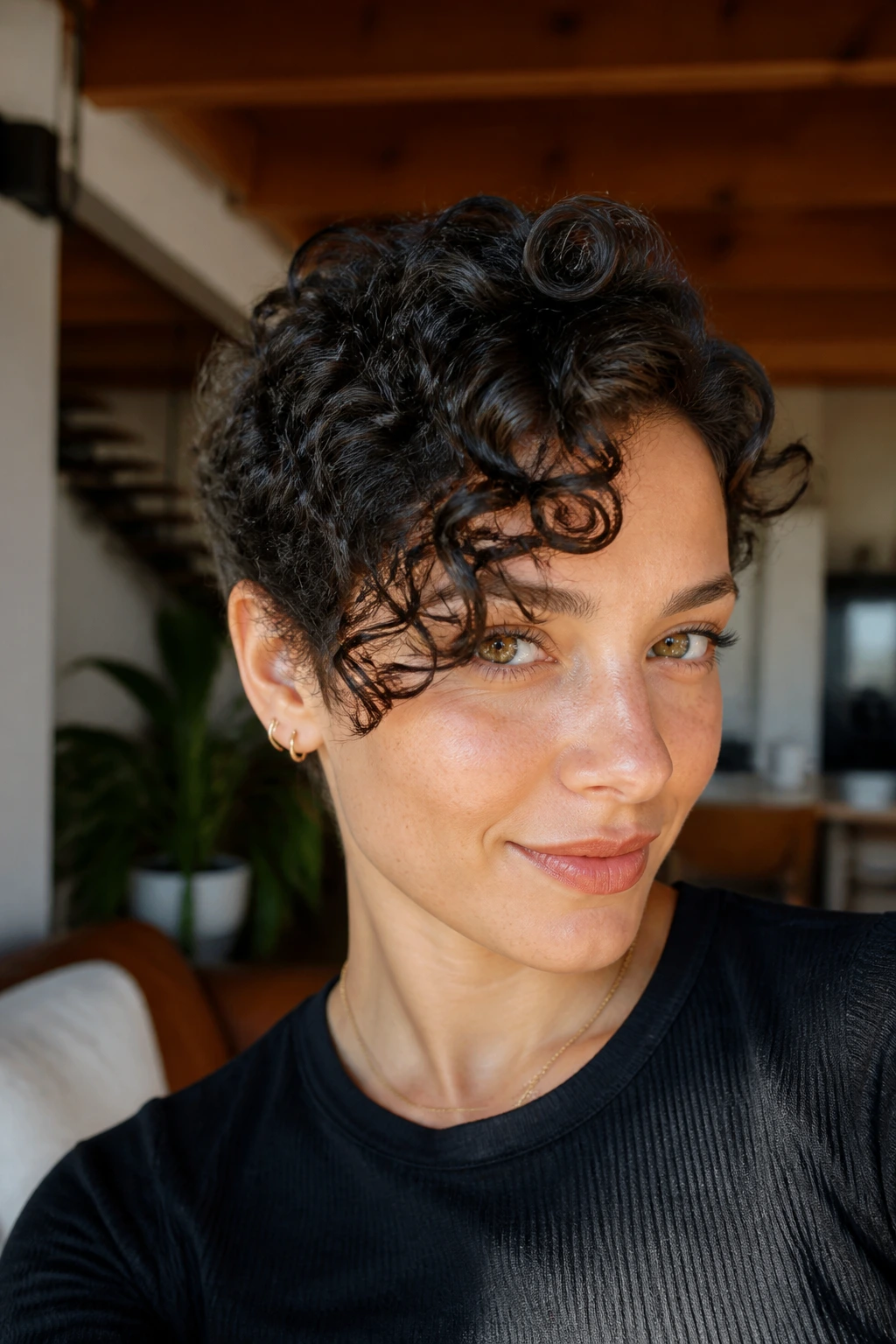Close-up portrait of a real woman with a curly crop and elongated front curl.