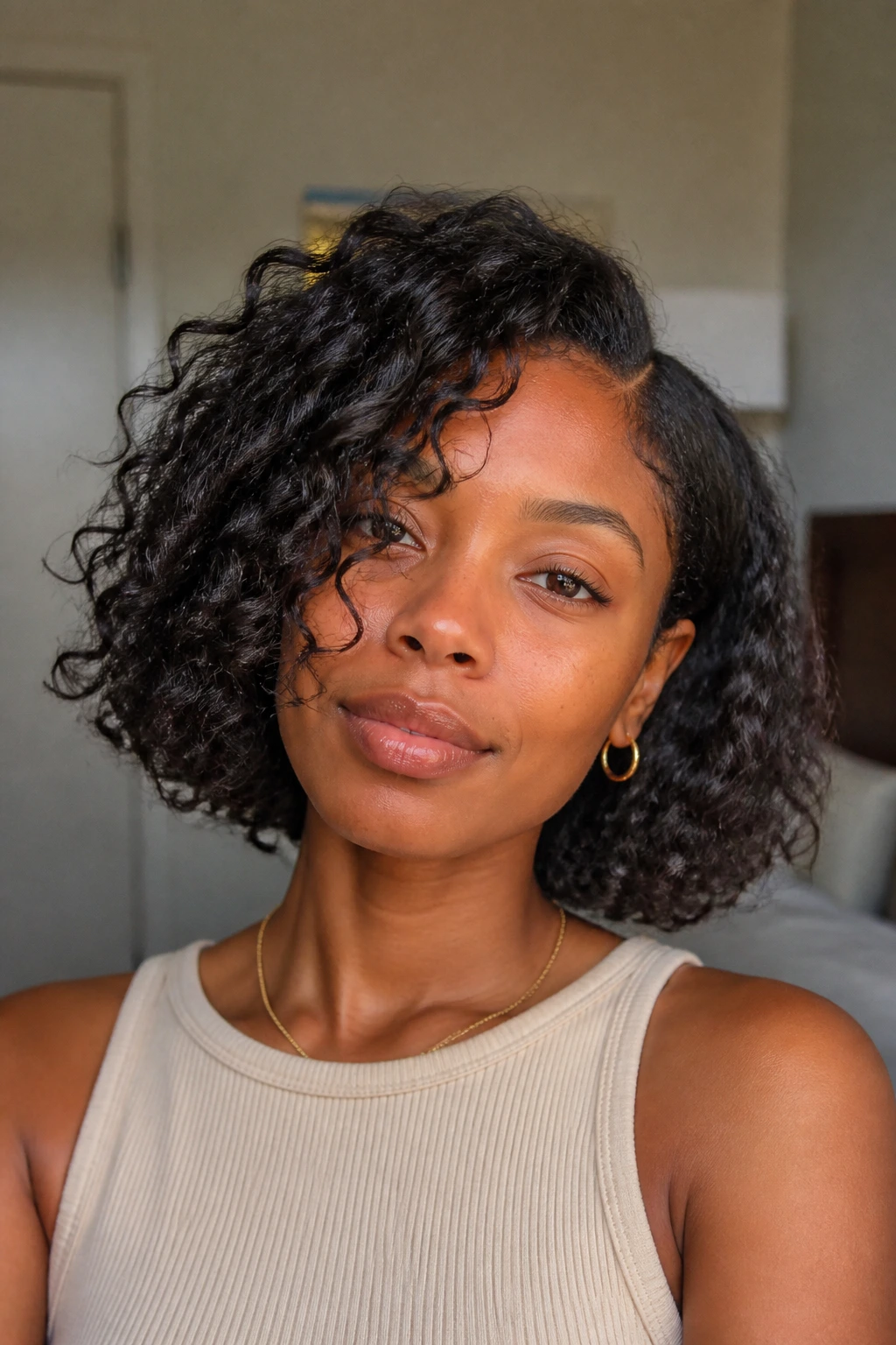 Curly lob on a real woman, jaw-skimming length with inner layers