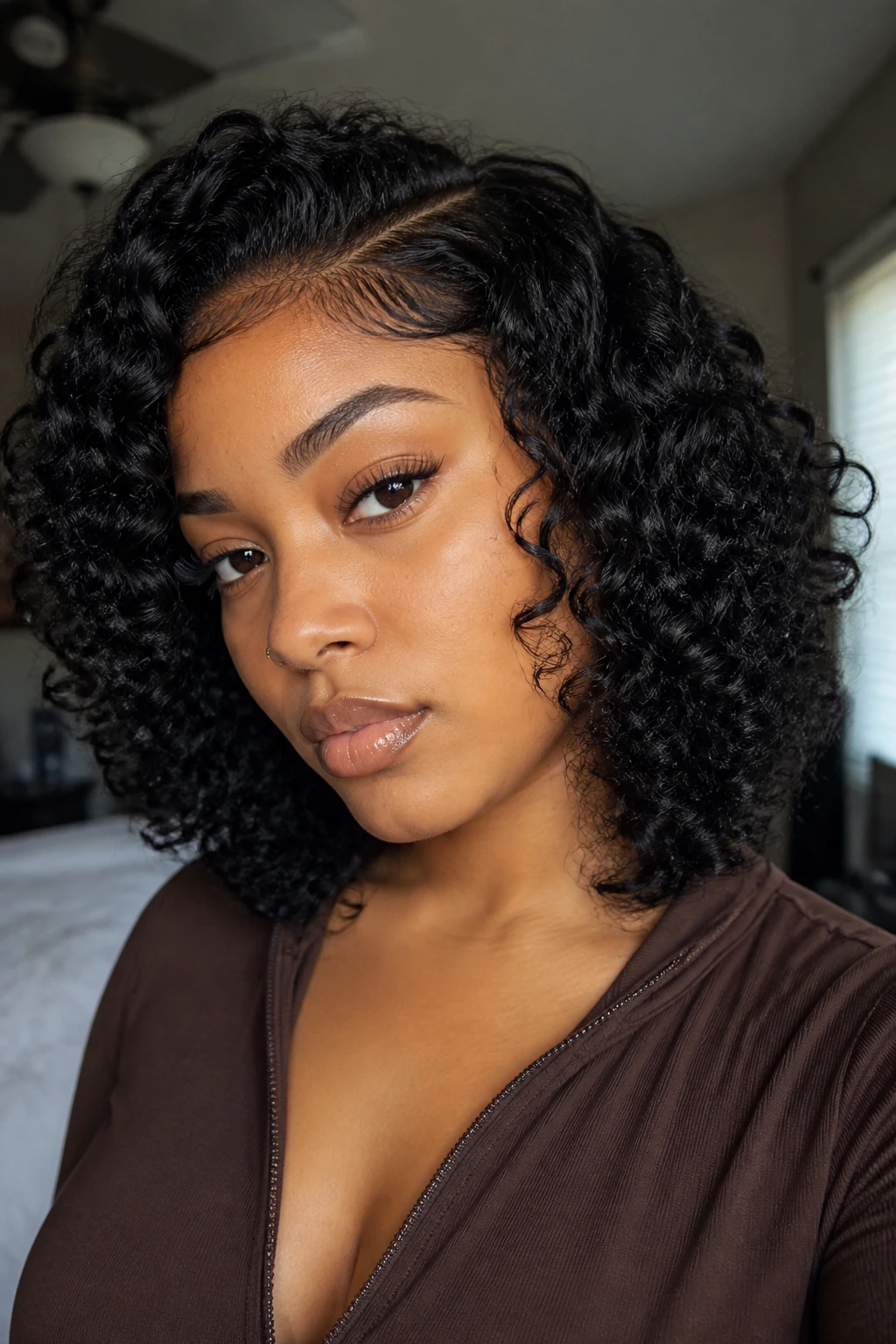 Close-up of a real woman wearing a curly wig with natural texture and hairline