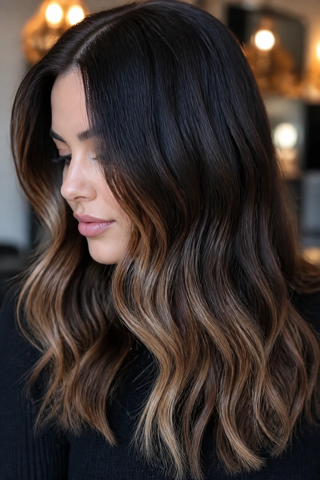 Close-up of a real woman with dark roast brunette hair and champagne caramel tips