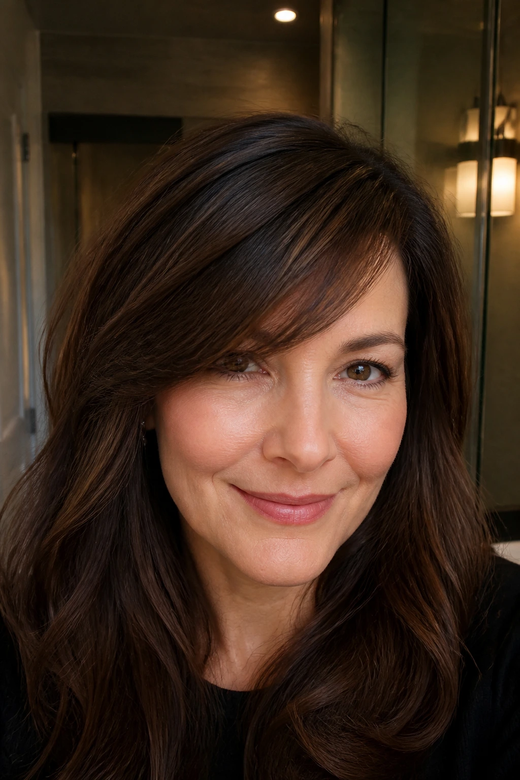 Close-up of a real woman with a de-bulked swept fringe for thick hair