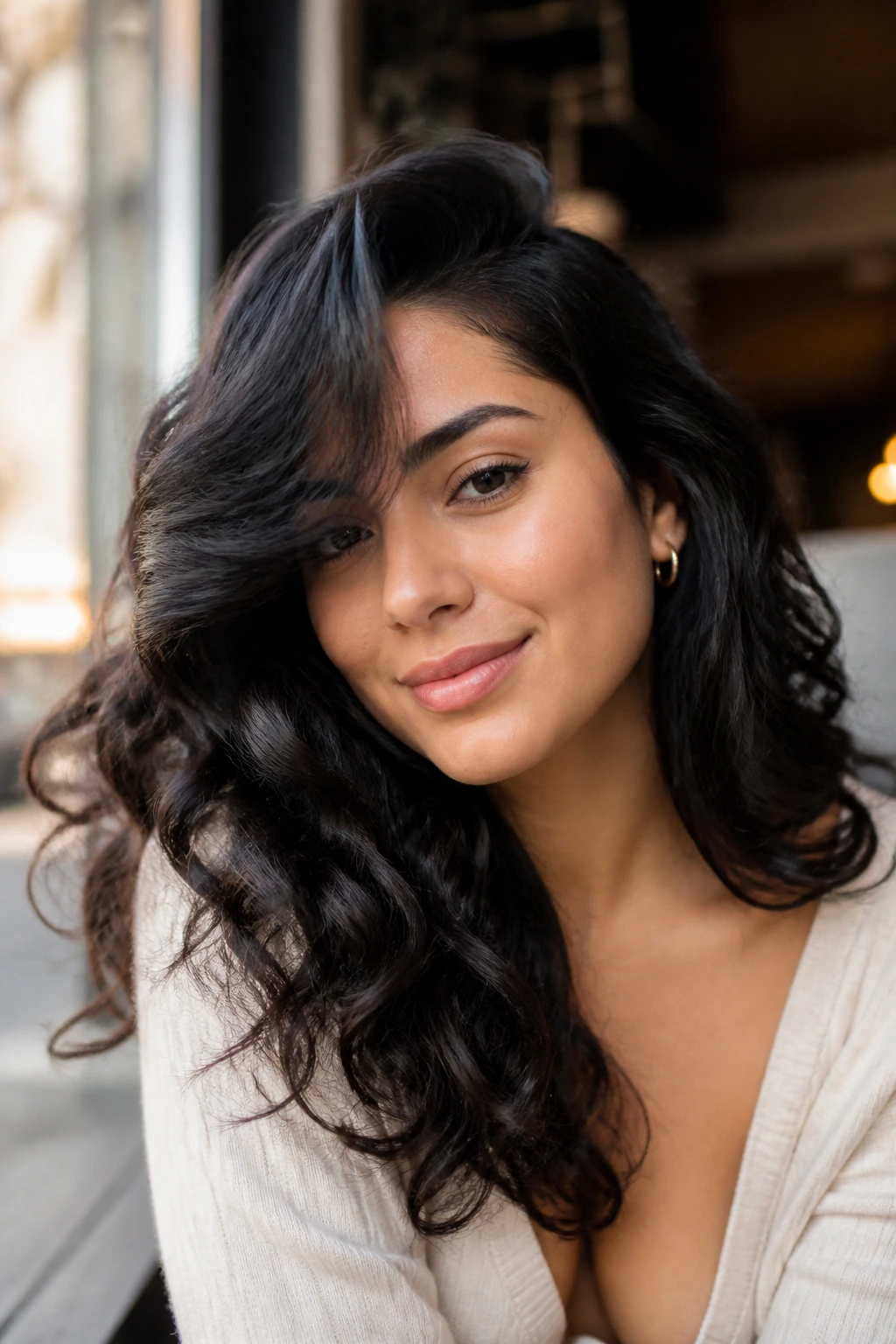 Portrait of a woman with deep side part curls and sweeping curtain fringe
