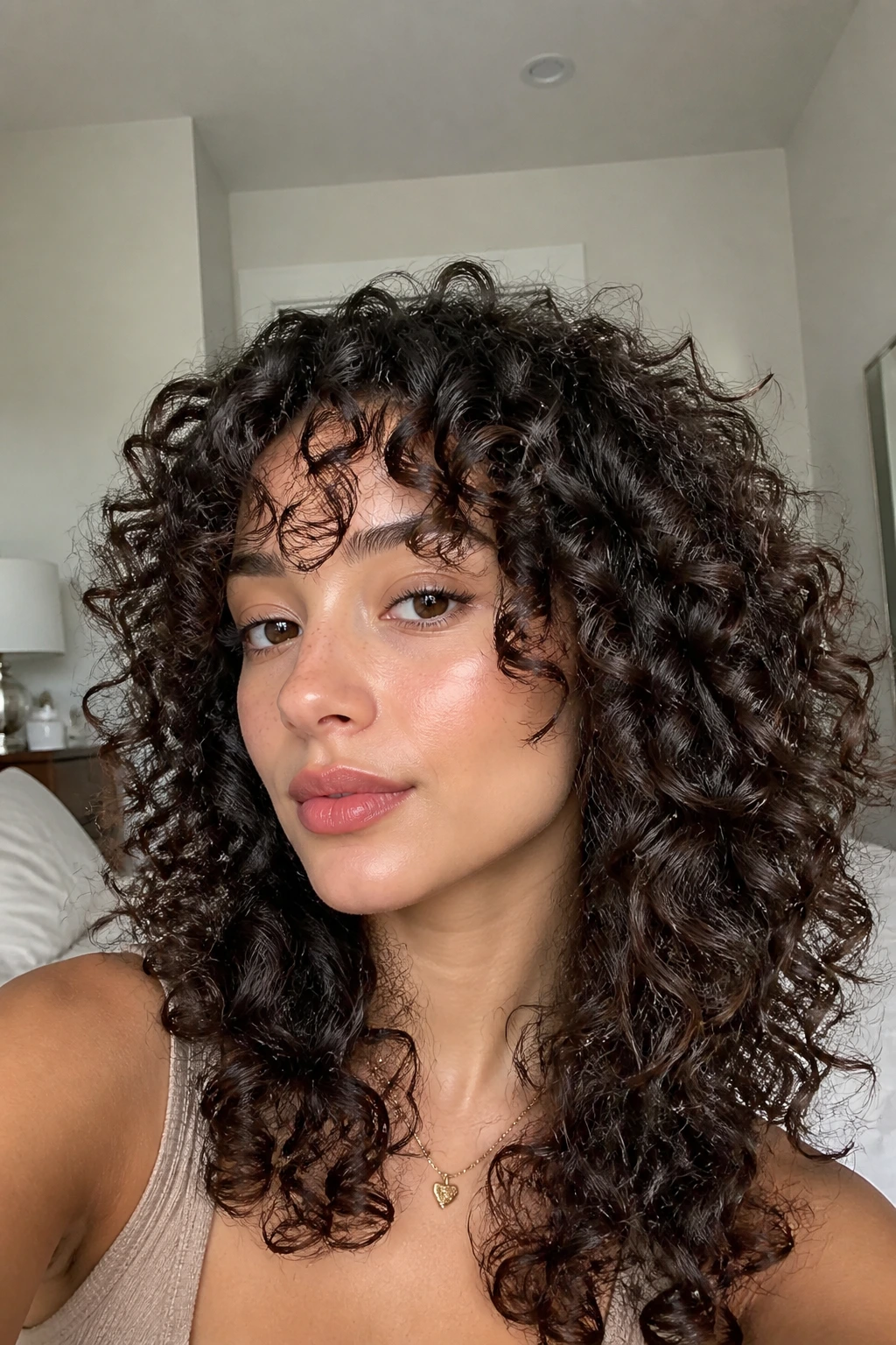 Close-up portrait of a real woman with defined ringlet curls forming a sculpted shag