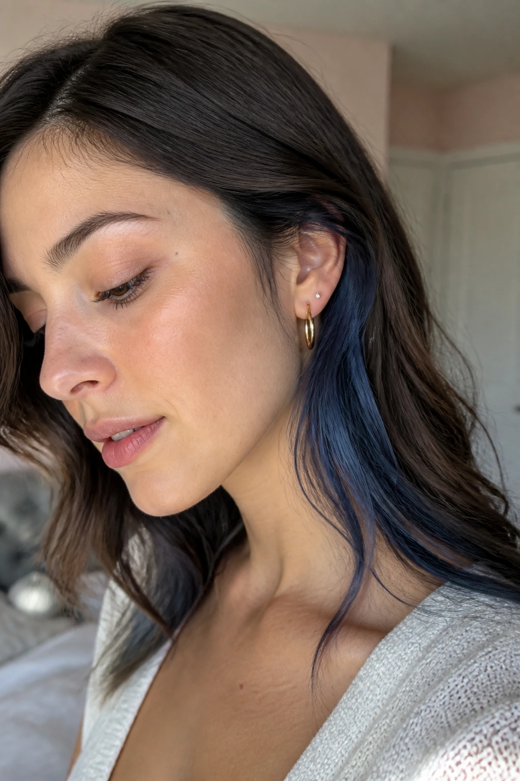 Close-up of a real person with denim blue peekaboo underlayer near the ear