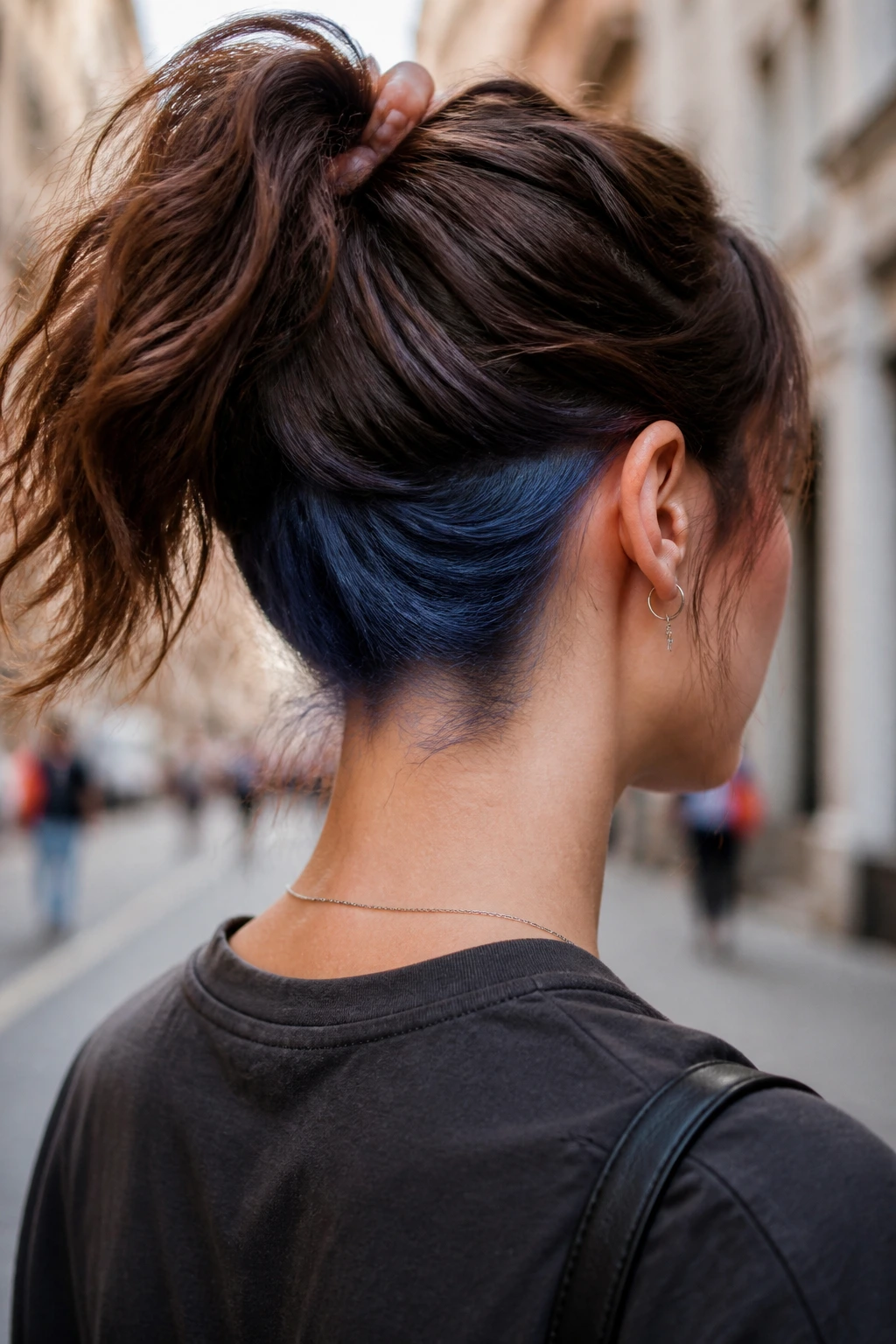 Portrait of a real woman showing denim blue nape block when hair is tied back