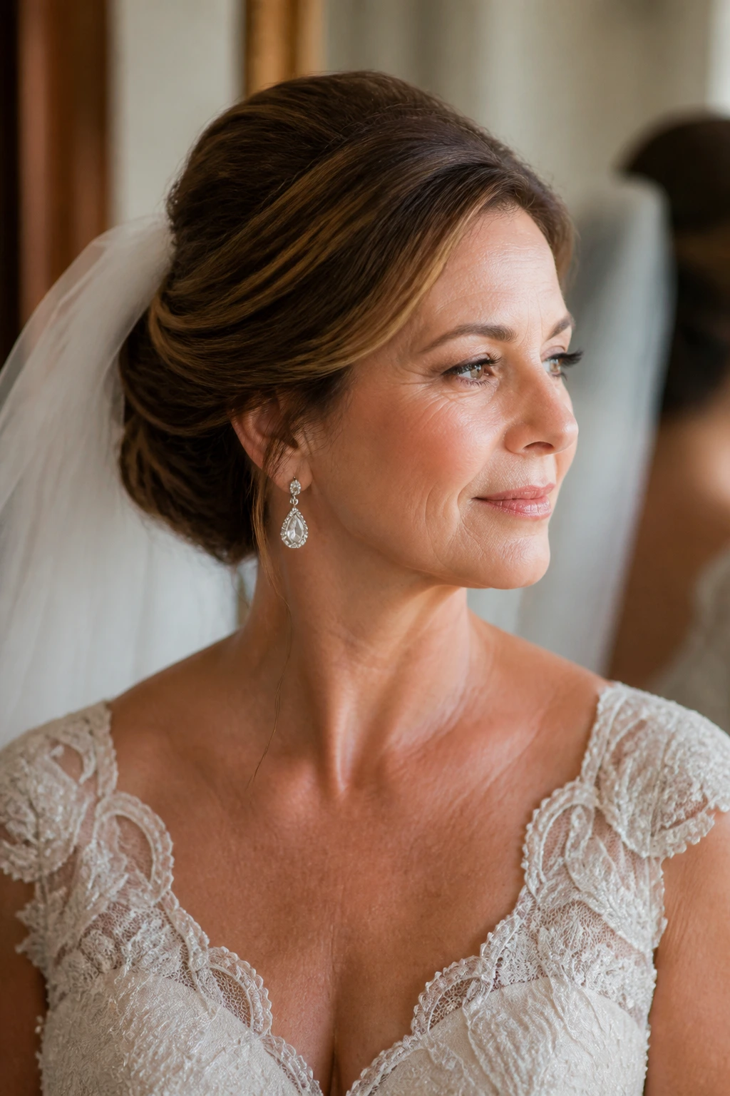 Bride with low bun and crown lift matching dress and veil