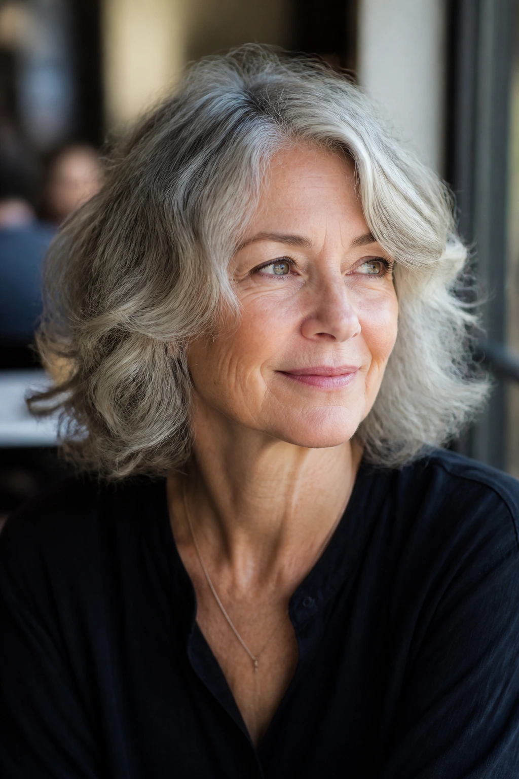 Older woman with an effortless wavy haircut in a cafe setting