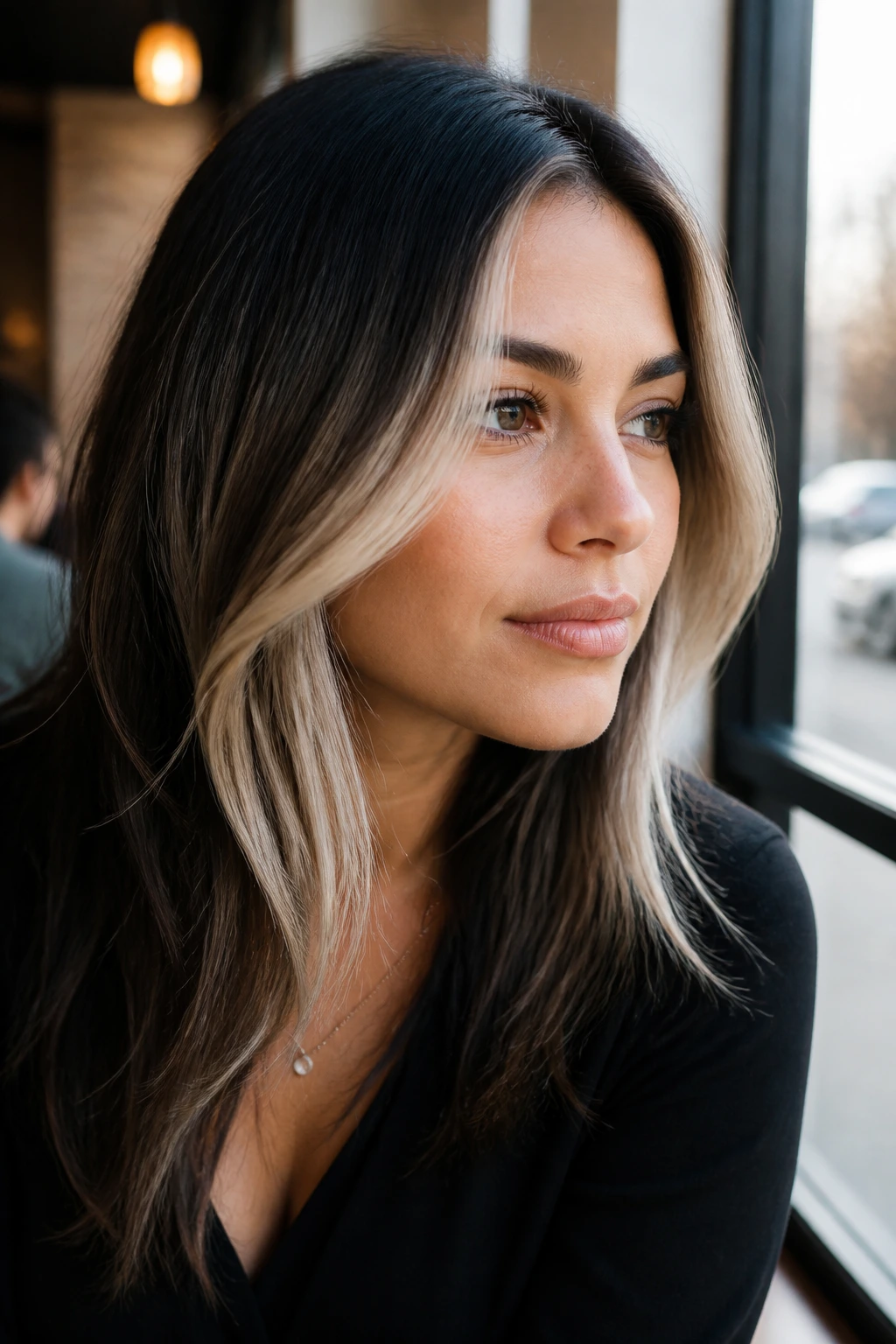 Portrait showing face-framing ice pieces on dark hair around the cheekbone.