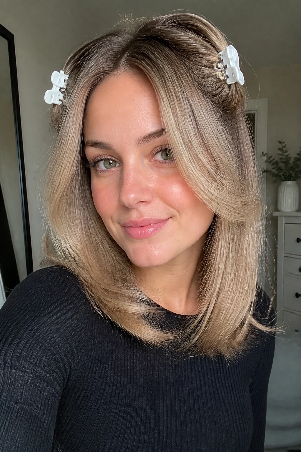 Close-up portrait of a real woman with a middle part and face-framing blowout