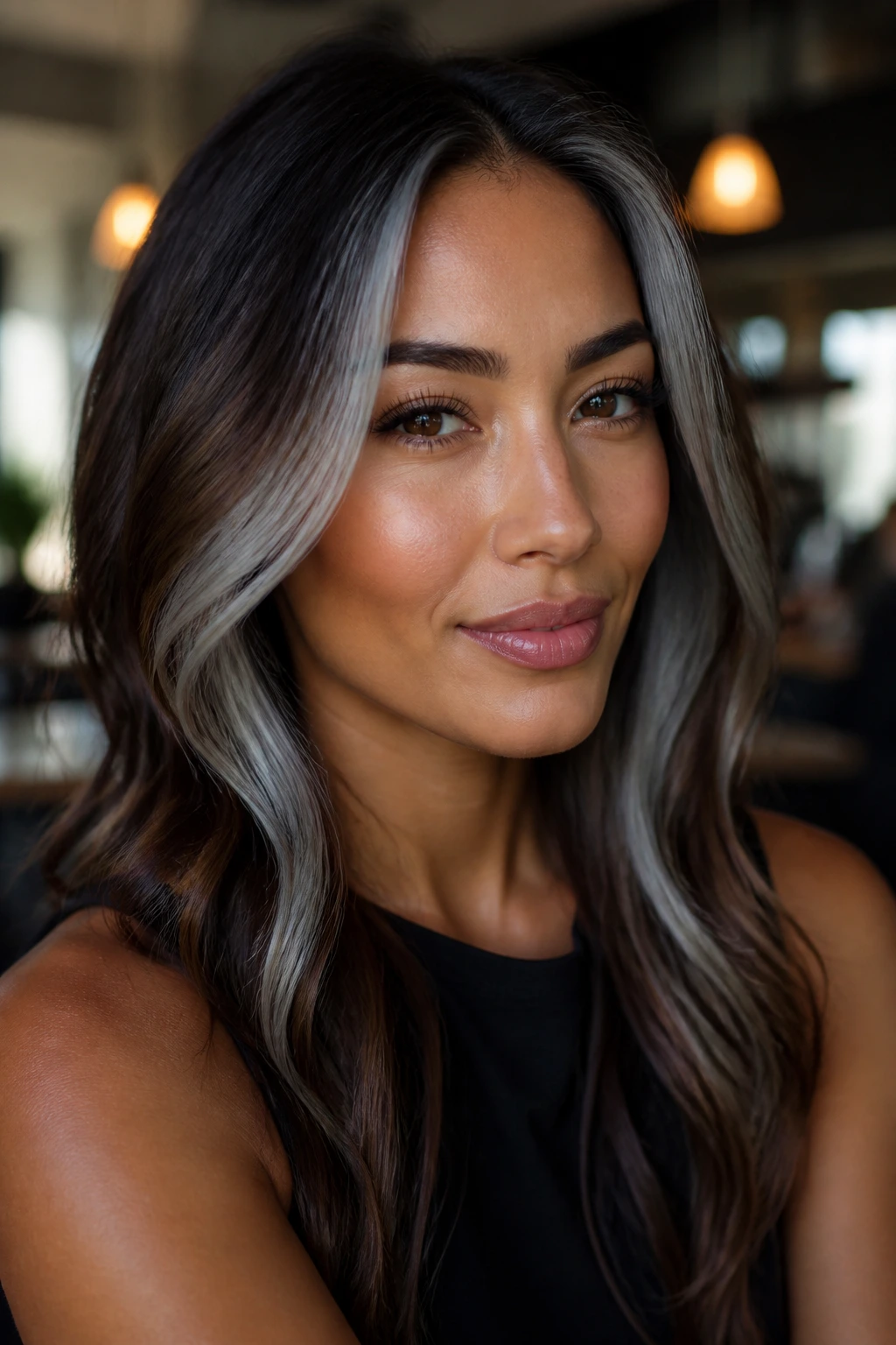 Portrait showing face-framing grey money pieces on brown hair.