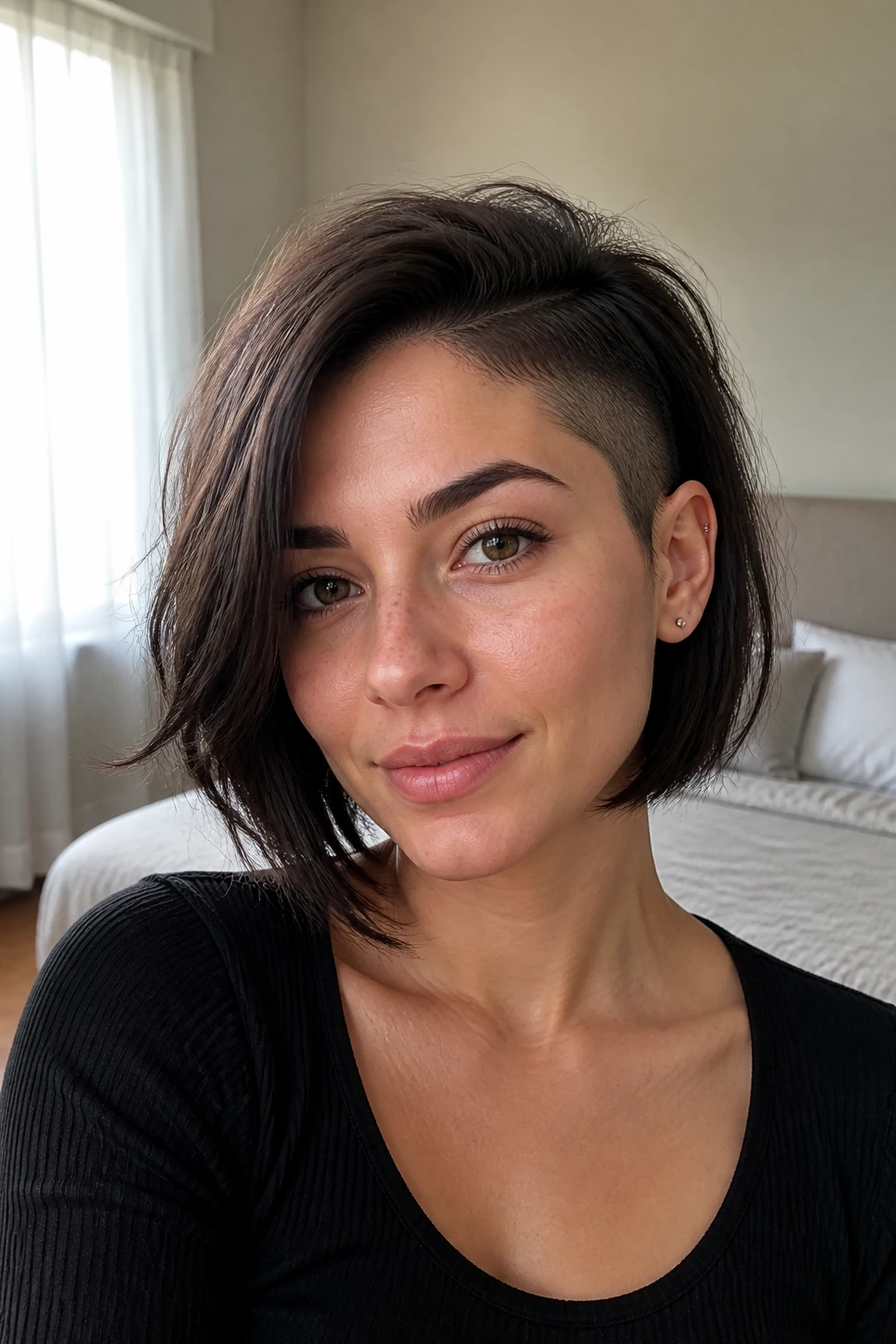 Close-up of a real woman with feathered-edge shaved bob in soft morning light.