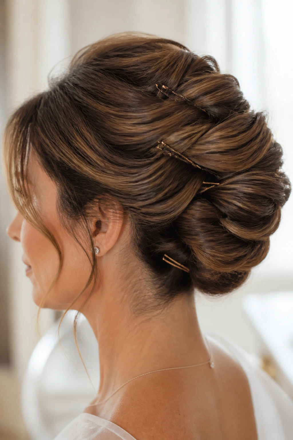 Real person with finished pinned updo showing pins securing the style