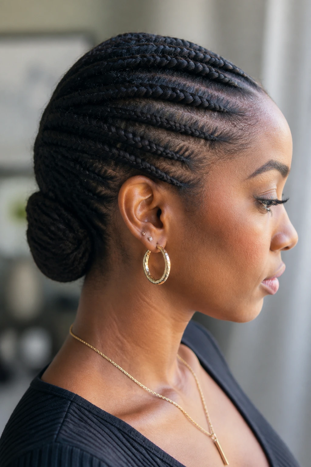 Close-up of flat-twist-inspired nape tuck hairstyle on real person