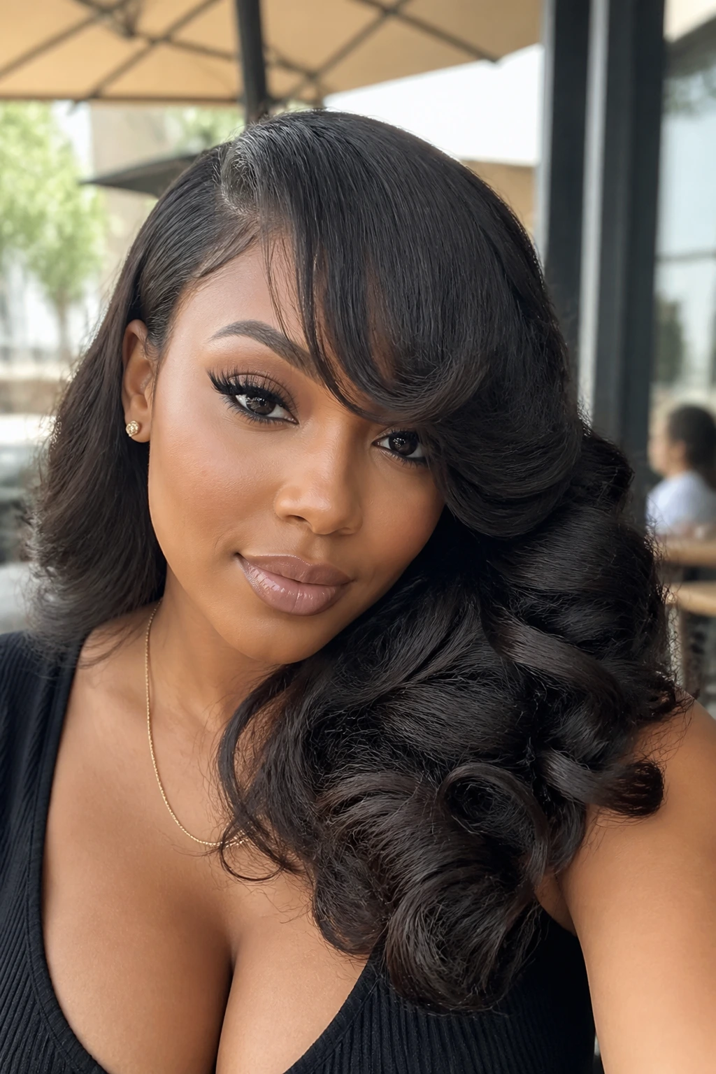 Close-up portrait of a real Black woman with flip-over curls and swooped fringe outdoors