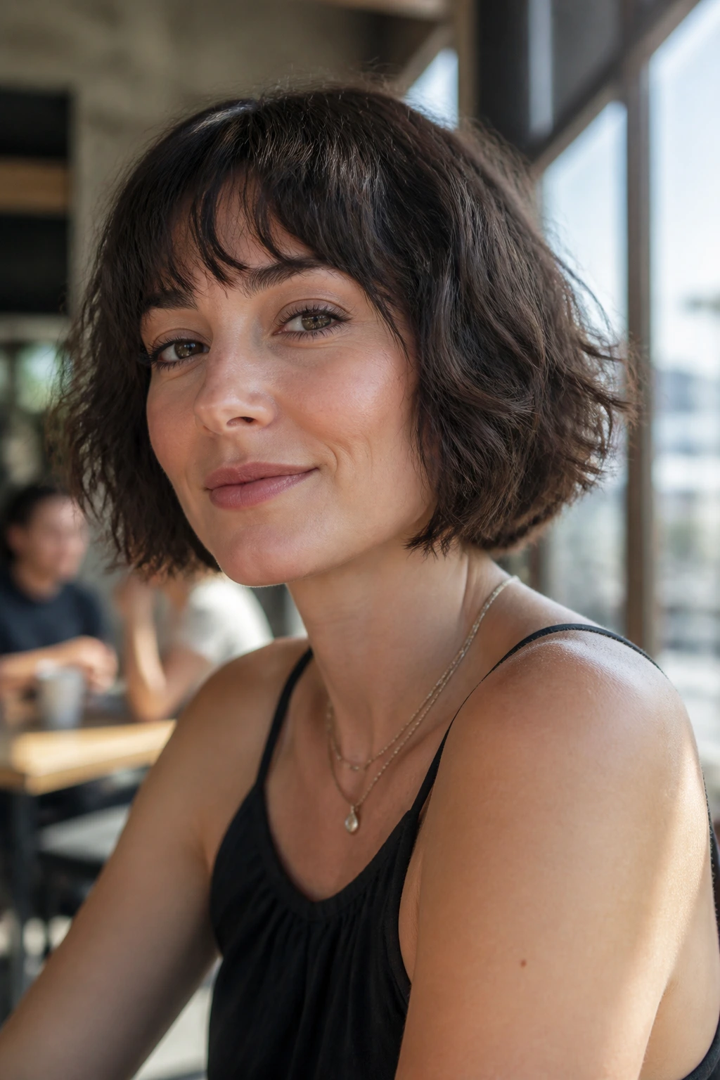 Close-up of a real woman with a French bob and piecey fringe.