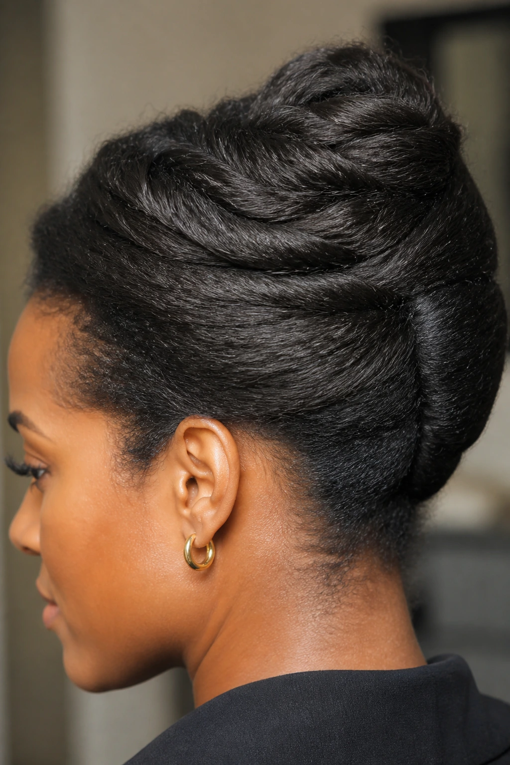 Close-up profile of a real woman with a French twist bun on thick hair