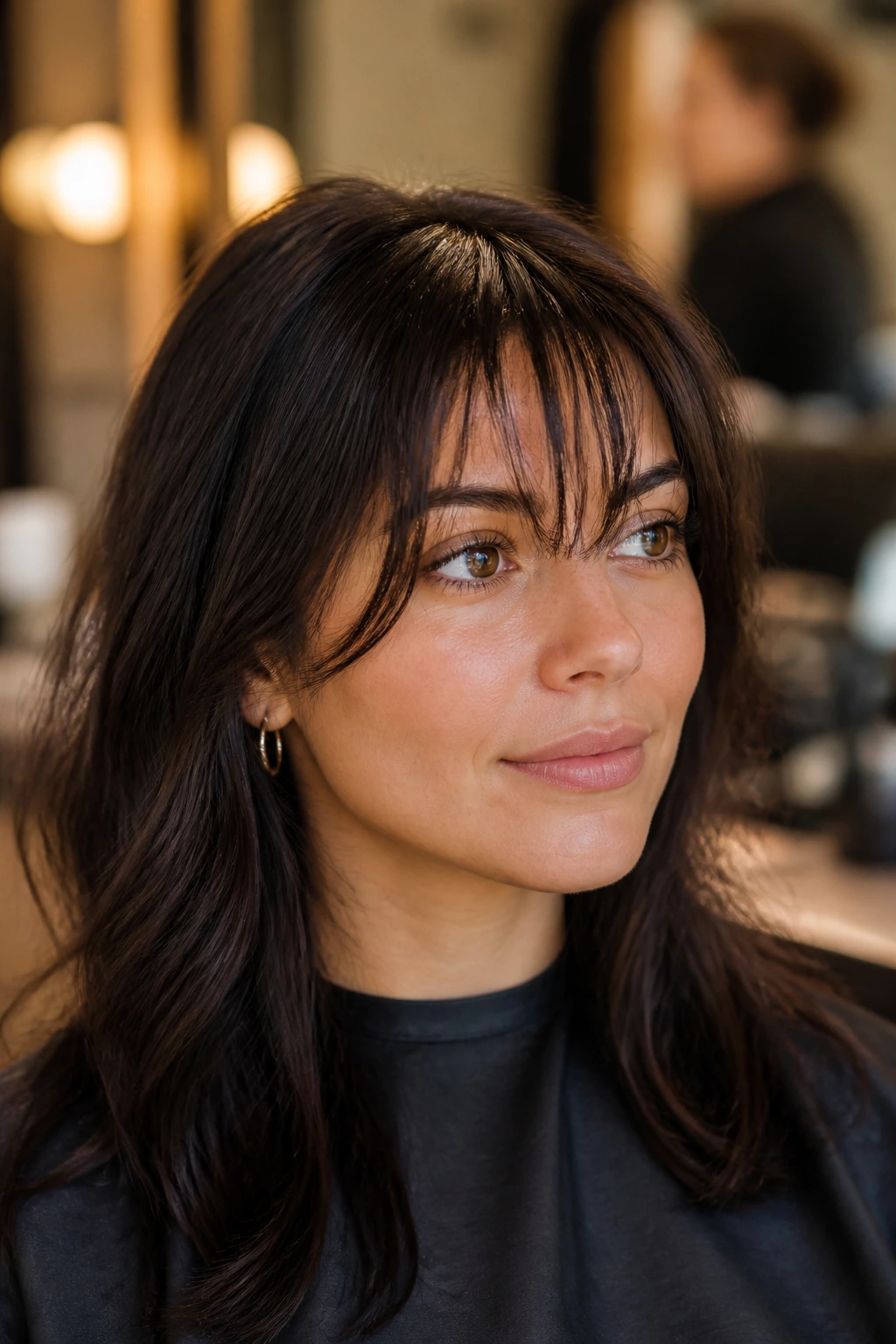 Portrait of a person in a salon chair with fringe ready for a trim
