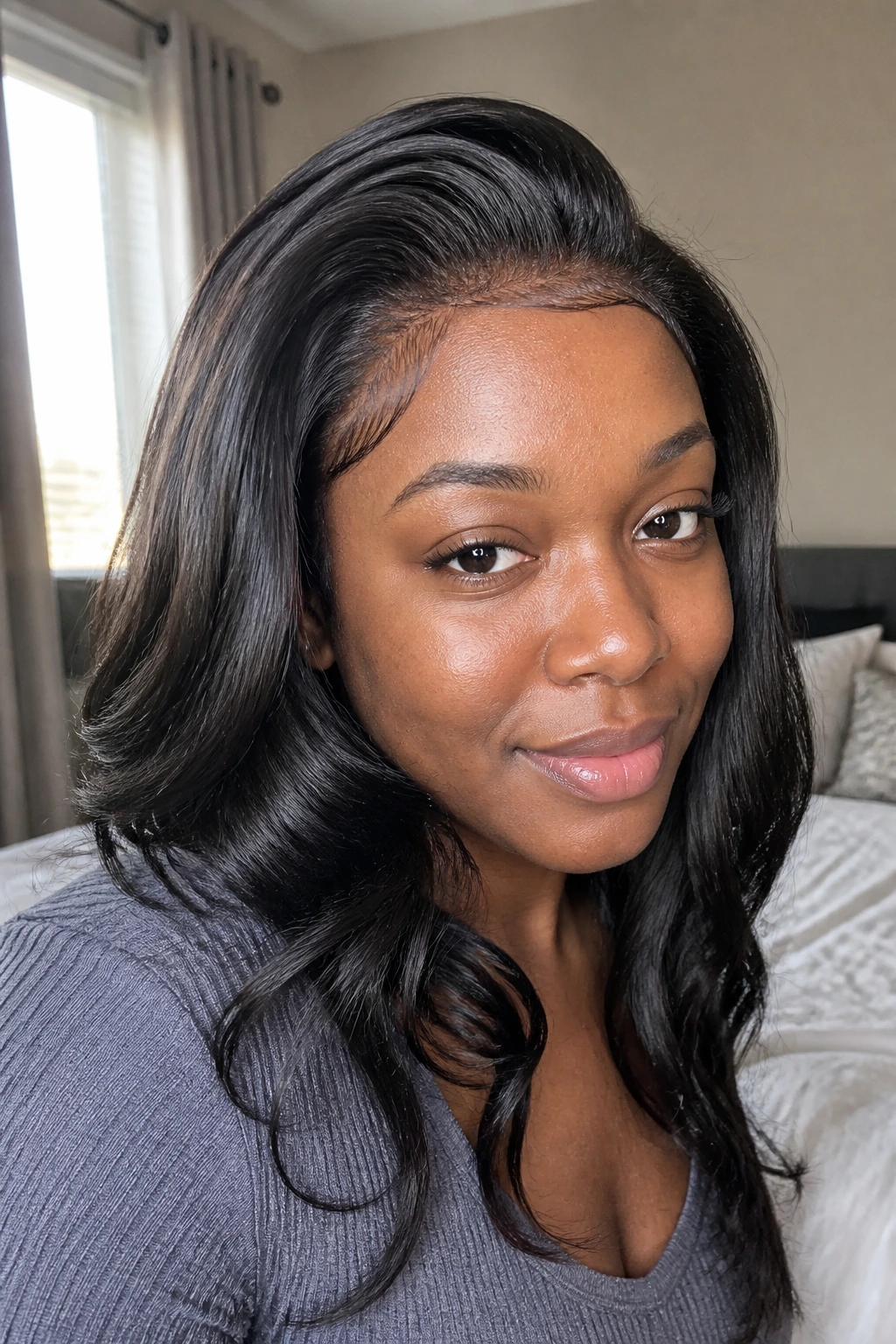 Close-up portrait of a real woman with a full-looking sew-in balanced for a light scalp load