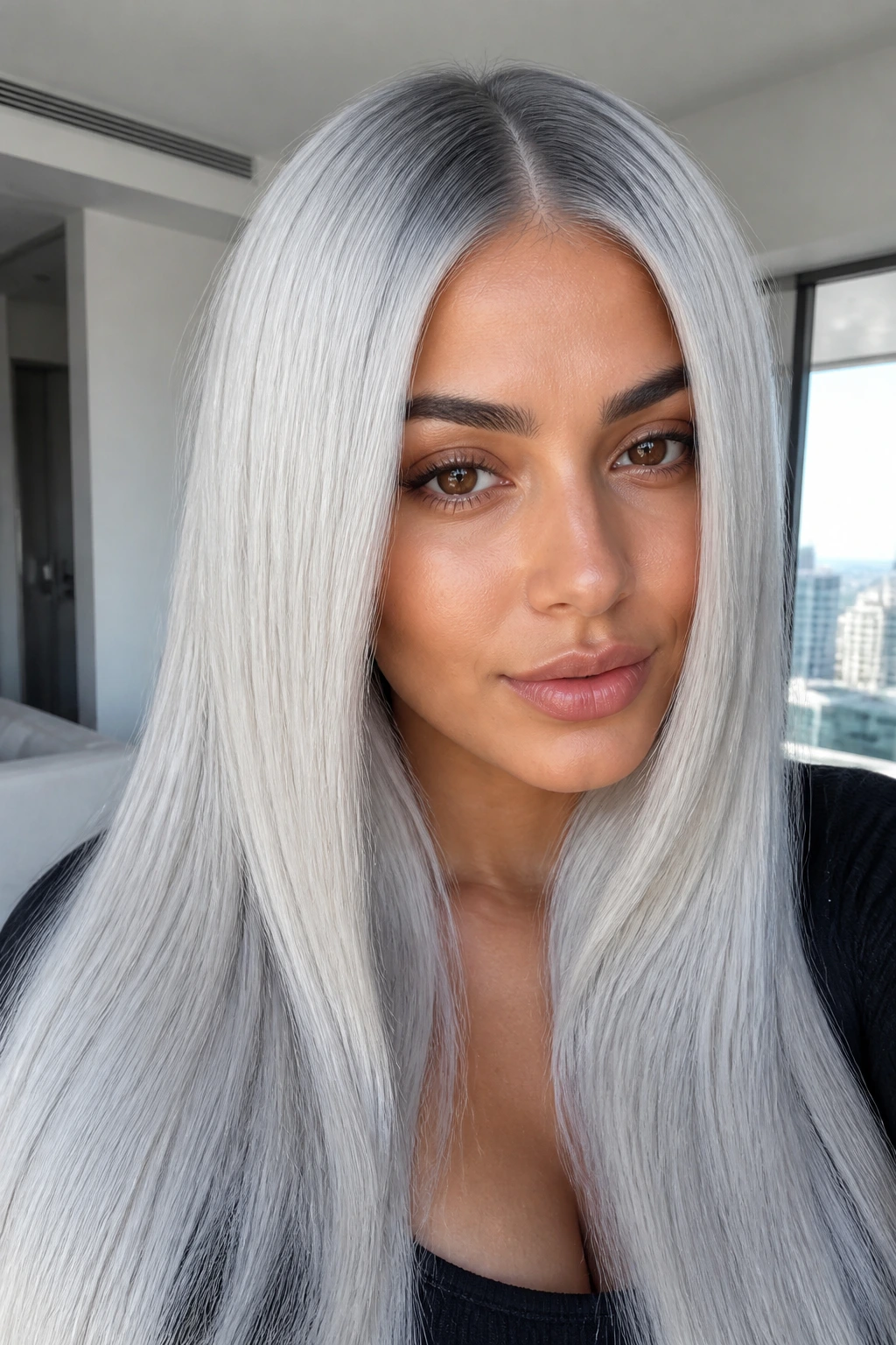 Portrait of a woman with sleek glass hair and center part.