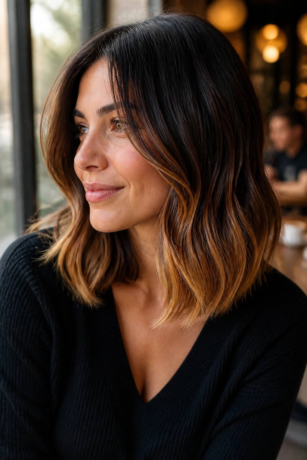Portrait of a real woman with glossy caramel ends on a lob hairstyle