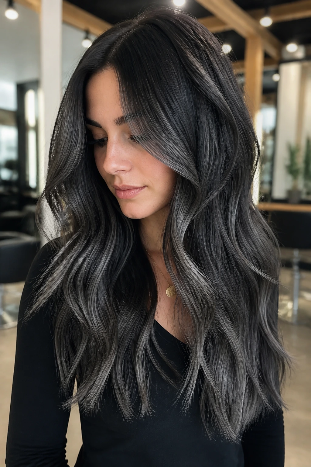Close-up of brunette hair with graphite balayage long layers and gray ribbons