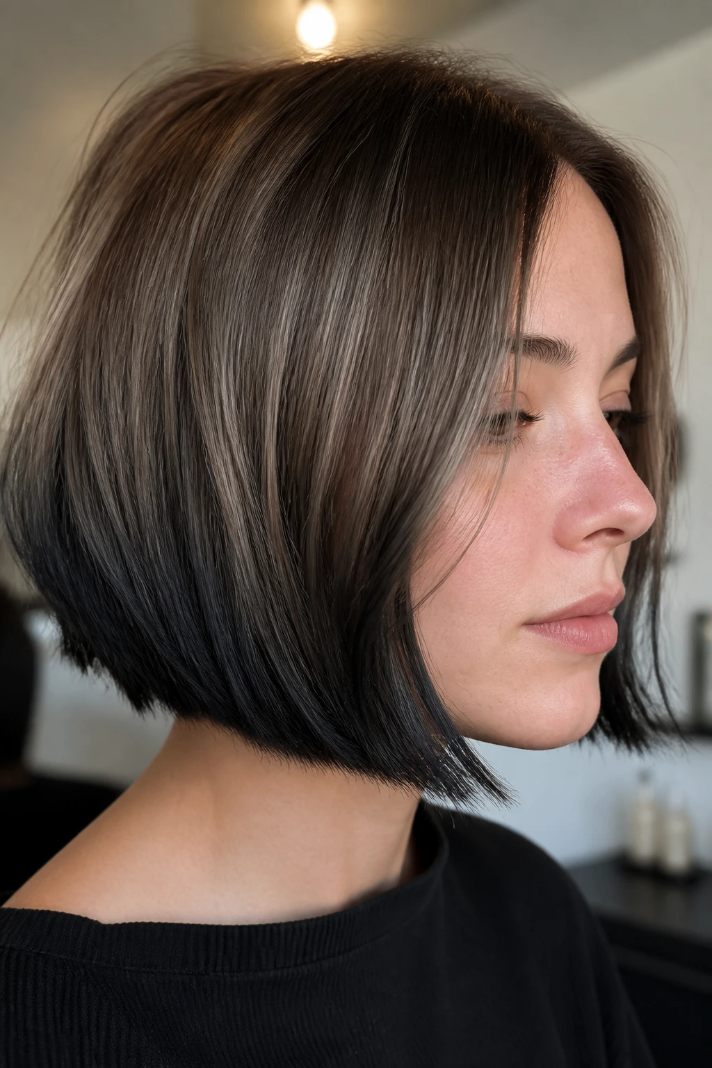 Close-up of a real woman with a bob featuring graphite-painted ends