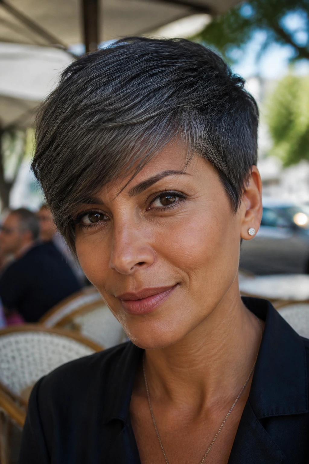 Close-up of olive-skinned person with graphite pixie and side-swept fringe