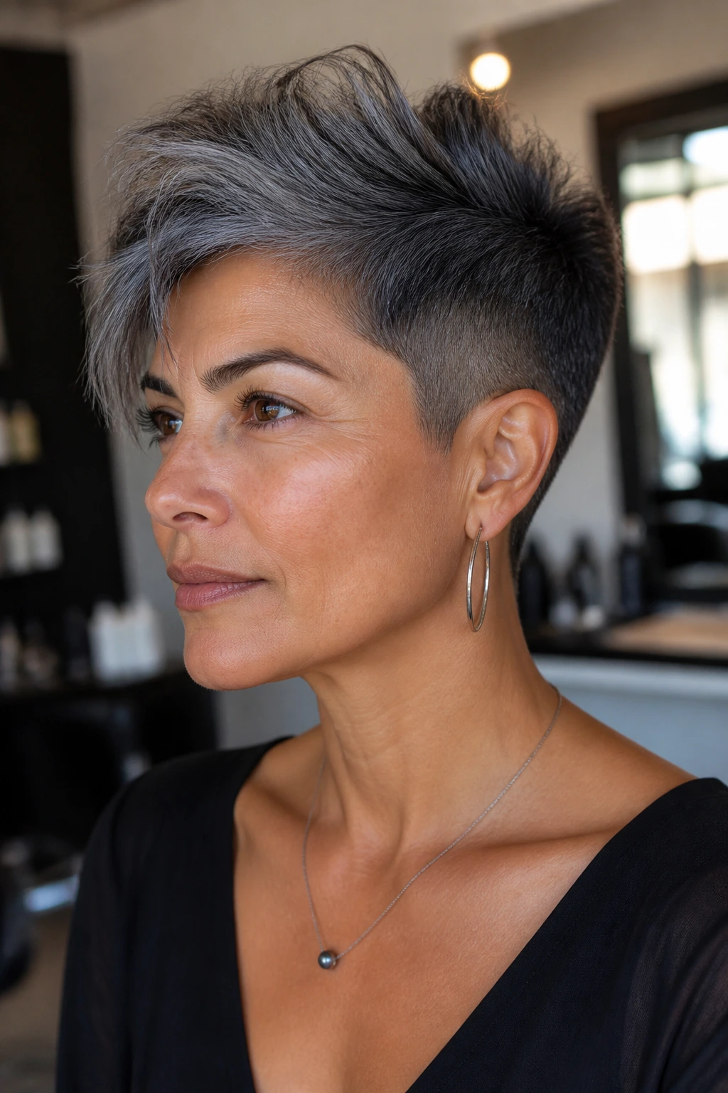 Close-up of a real person with graphite undercut pixie on olive skin