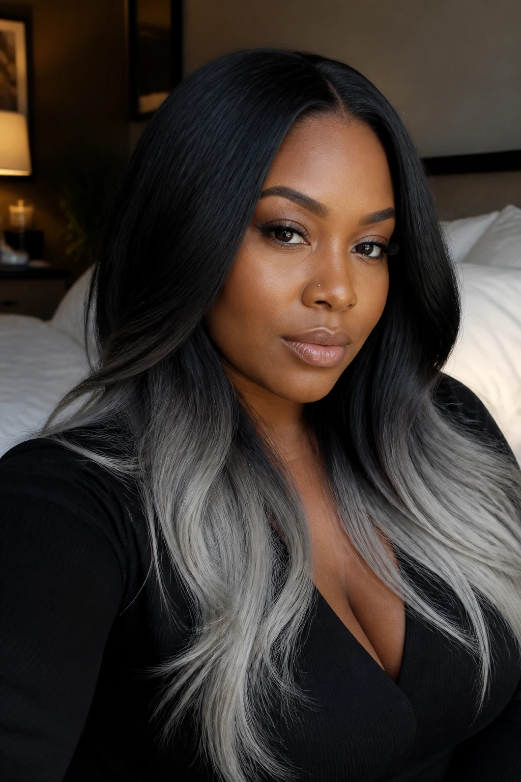 Close-up portrait of a real woman showcasing Black Pearl with Frosted Ends hair: dark roots to frosted ends