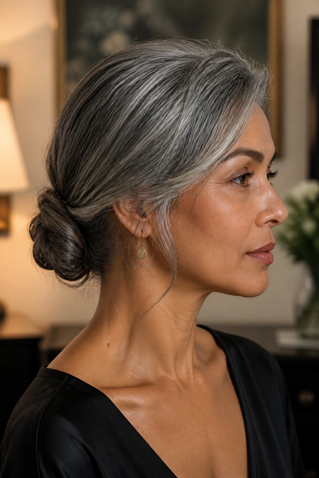 Profile view of a real person wearing a low chignon with side sweep.