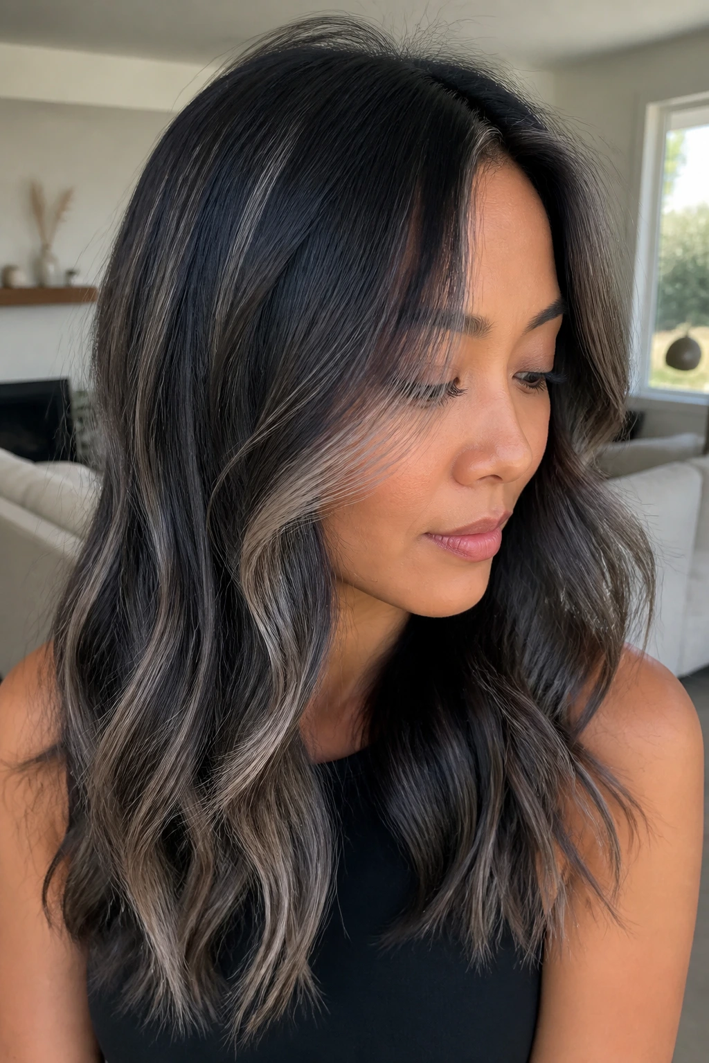 Real person with grey-black hair showing variations and face-framing lighter pieces.