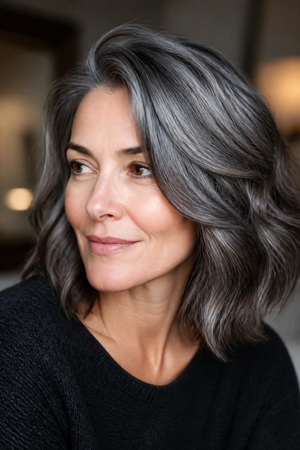Close-up of glossy grey hair catching light in a warm setting