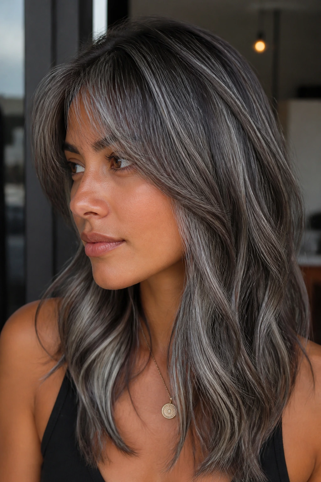 Close-up portrait of a real woman with gunmetal ribbon highlights in hair