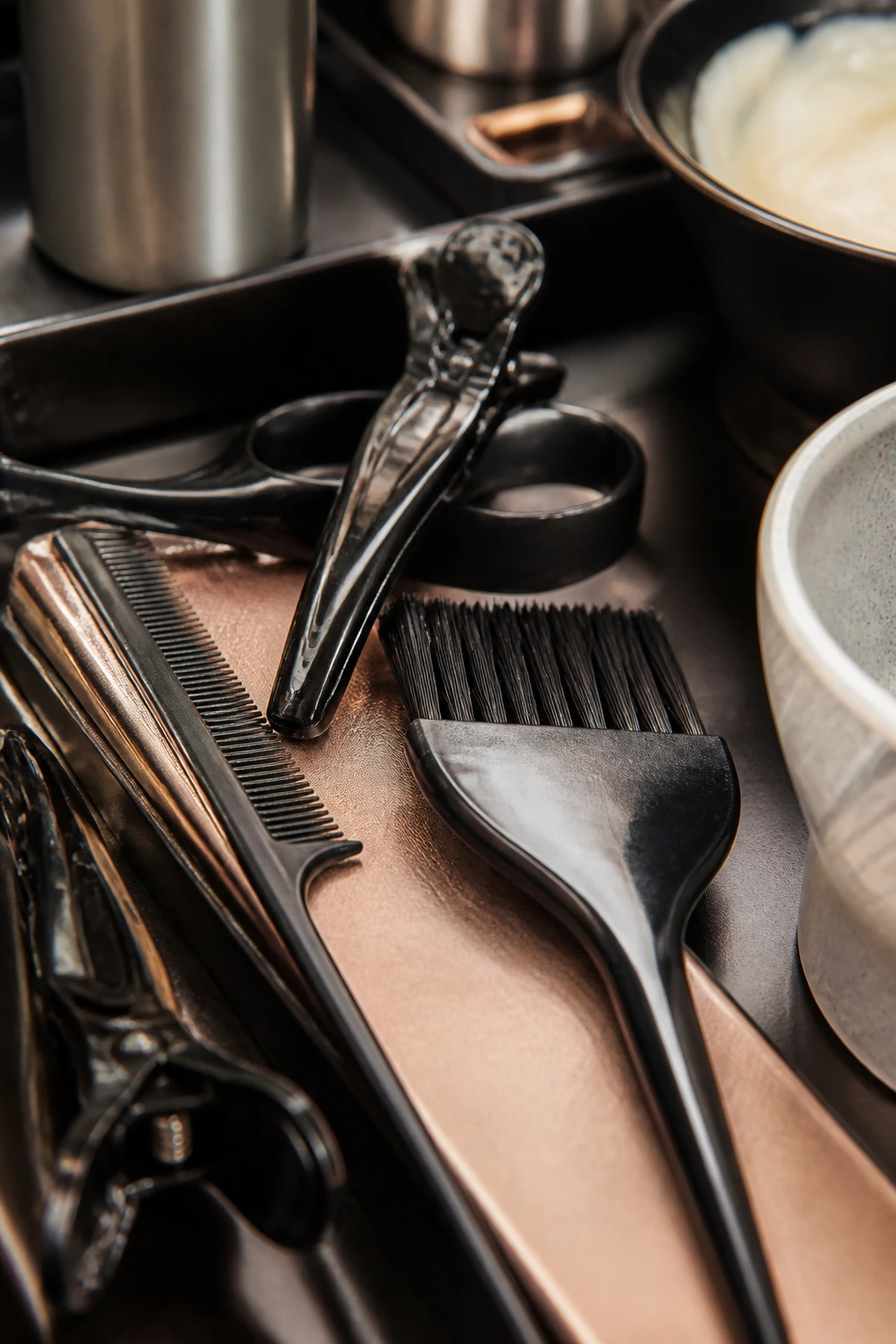 Close-up cluster of essential hair coloring tools on a clean surface