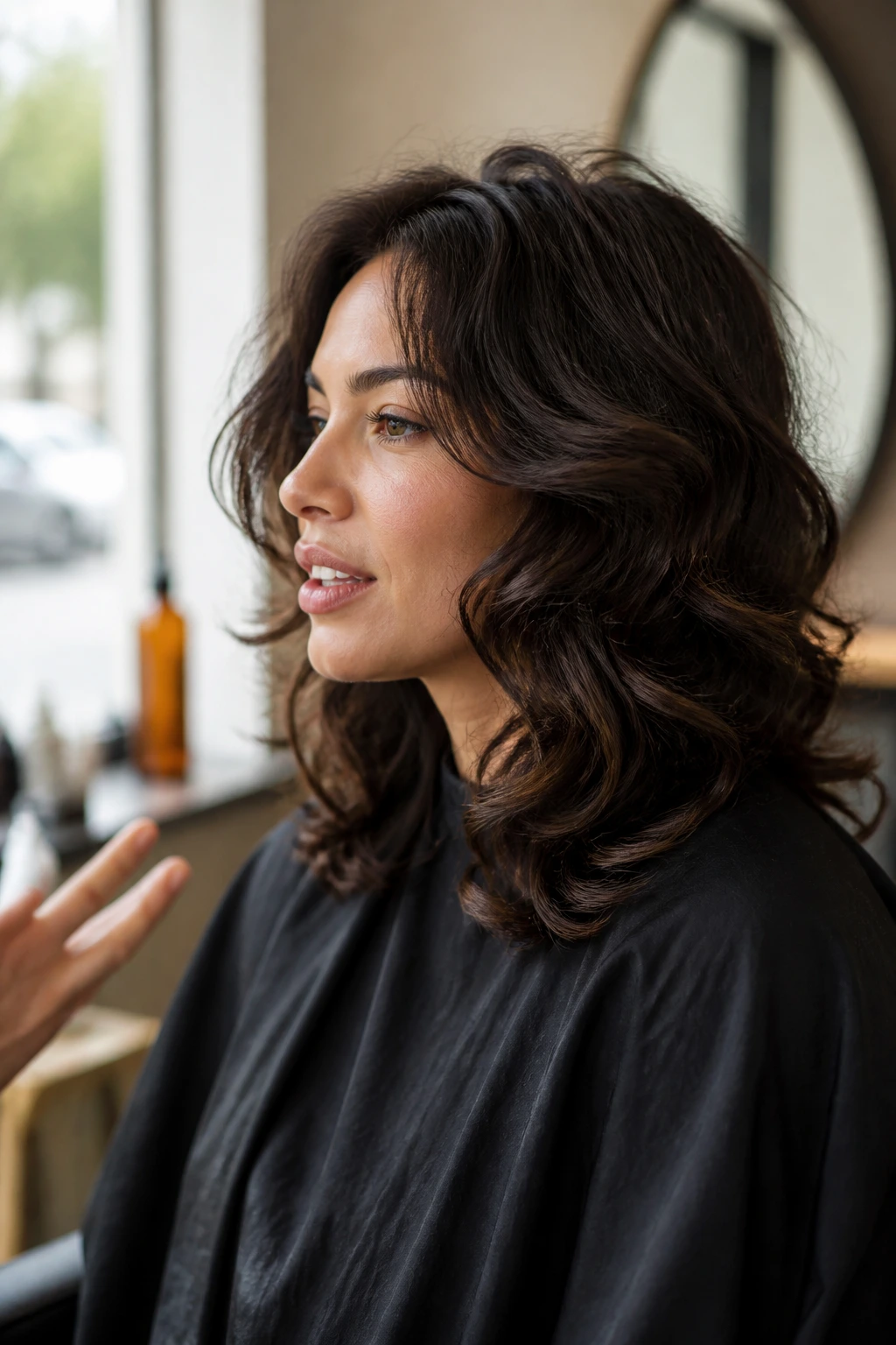Side-profile portrait of a woman in a salon consultation about haircut