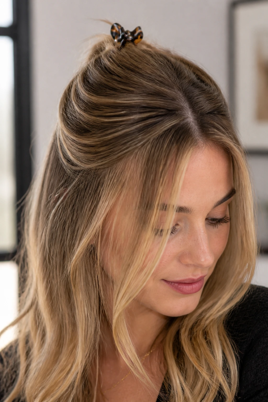 Close-up of real woman with half-up crown lift secured with a small clip.