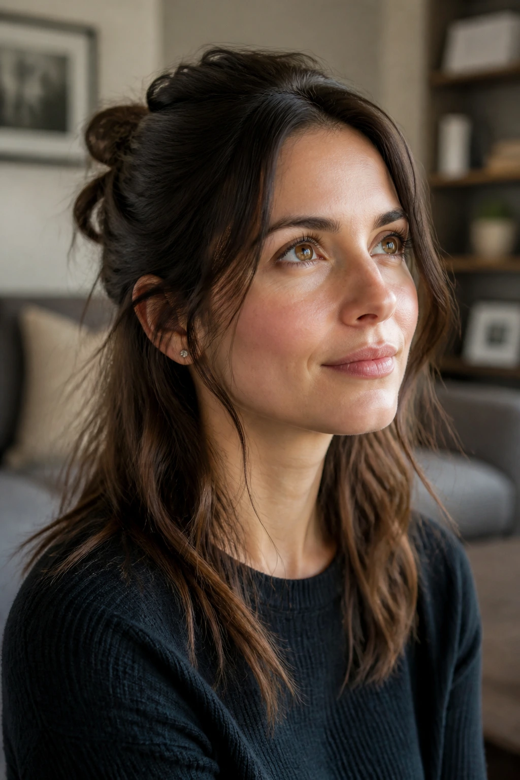 Close-up of a real woman with a soft half-up knot and crown volume under daylight.