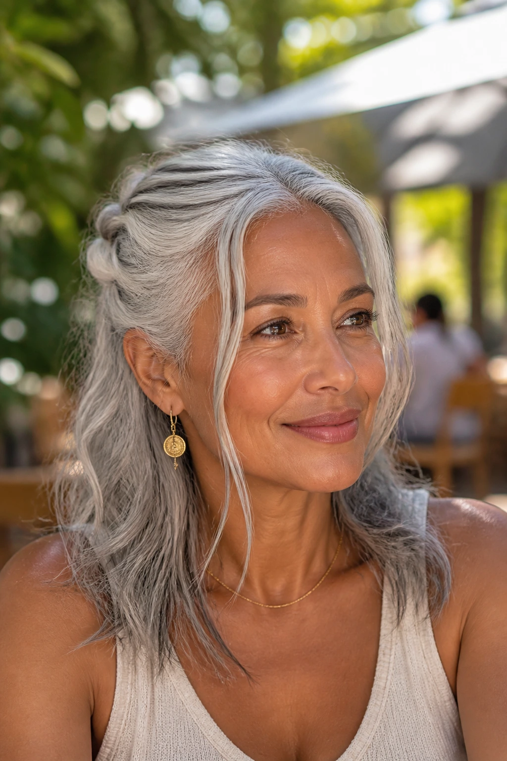 Portrait of a real person with a half-up silver twist and loose ends.