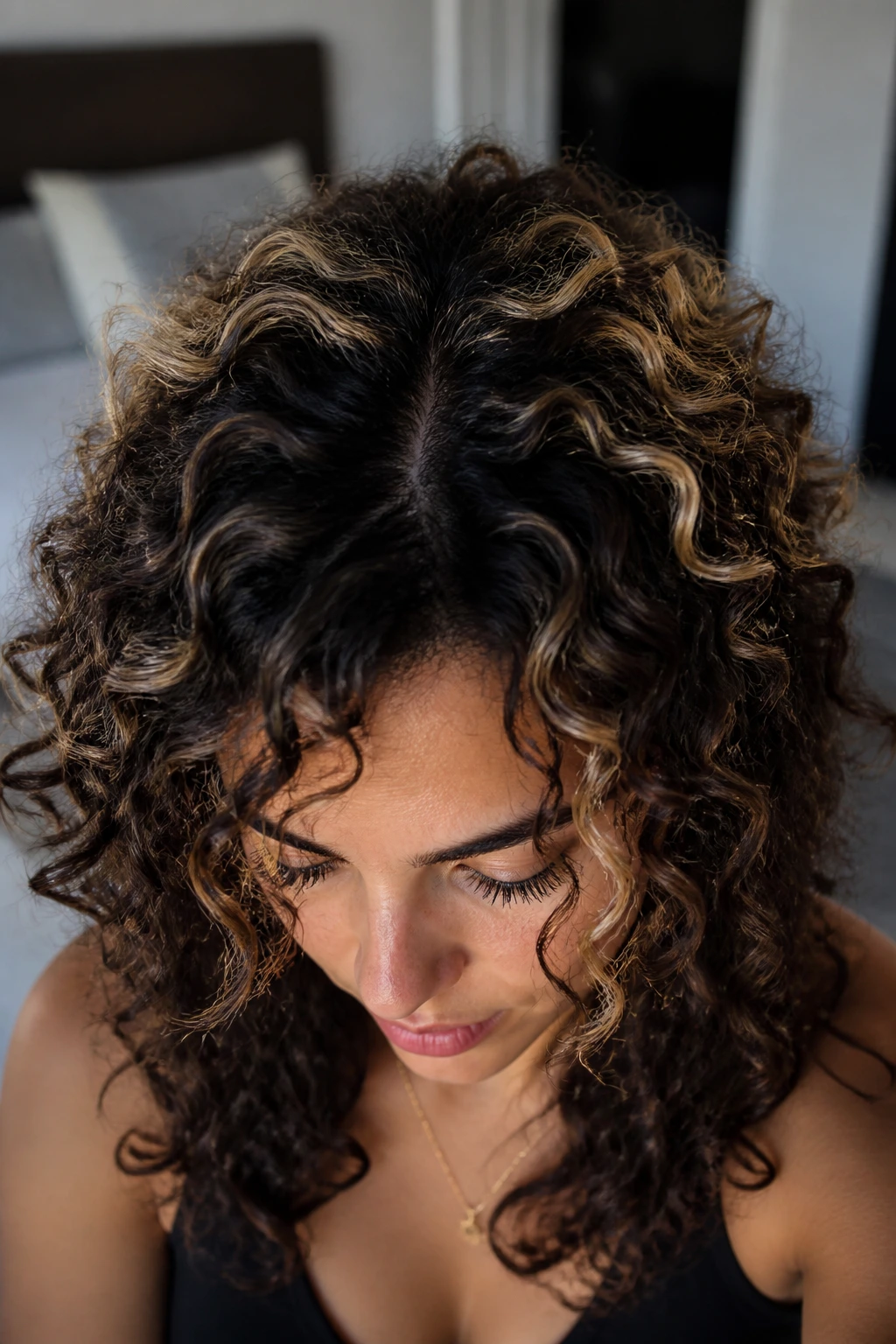 Halo lights around crown on dark curly hair