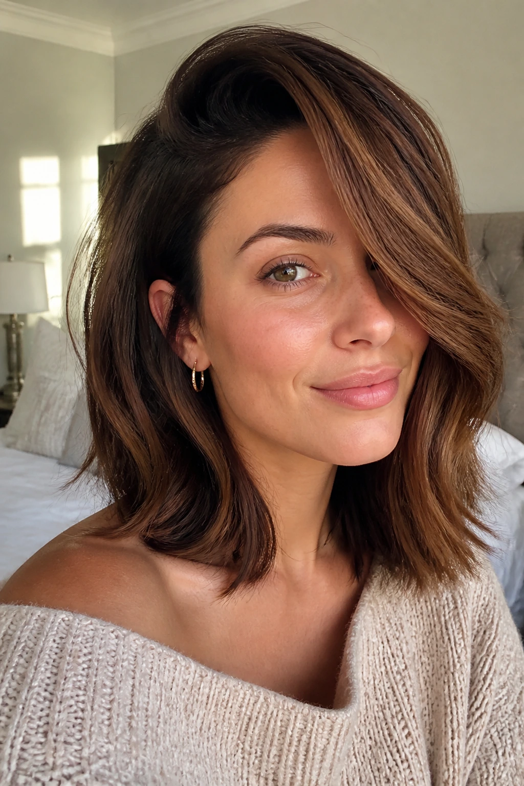 Close-up portrait of a woman with hazelnut lob and deep side sweep