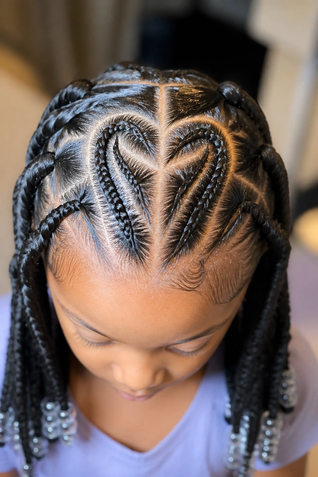 Child with heart part cornrows showing variation