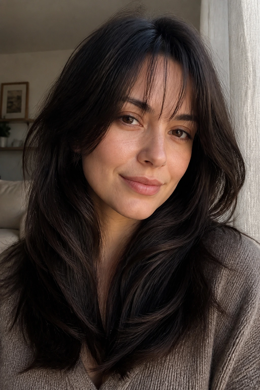 Close-up portrait of a real woman with crown-like layers and sparse fringe
