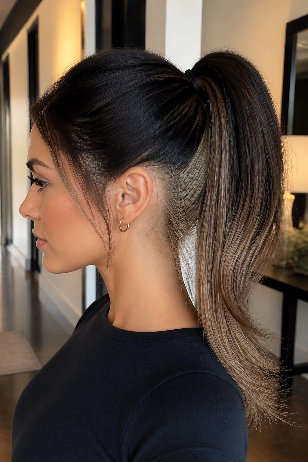 Side-profile of a woman with a high ponytail and hidden blonde panels