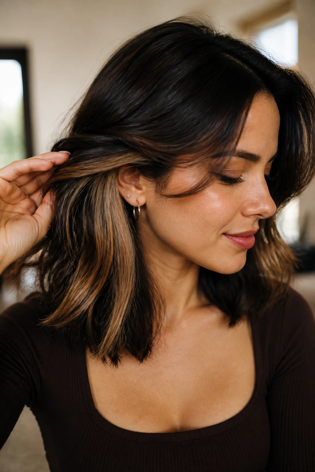 Close-up of real person with honey peekaboo panels peeking from under dark hair