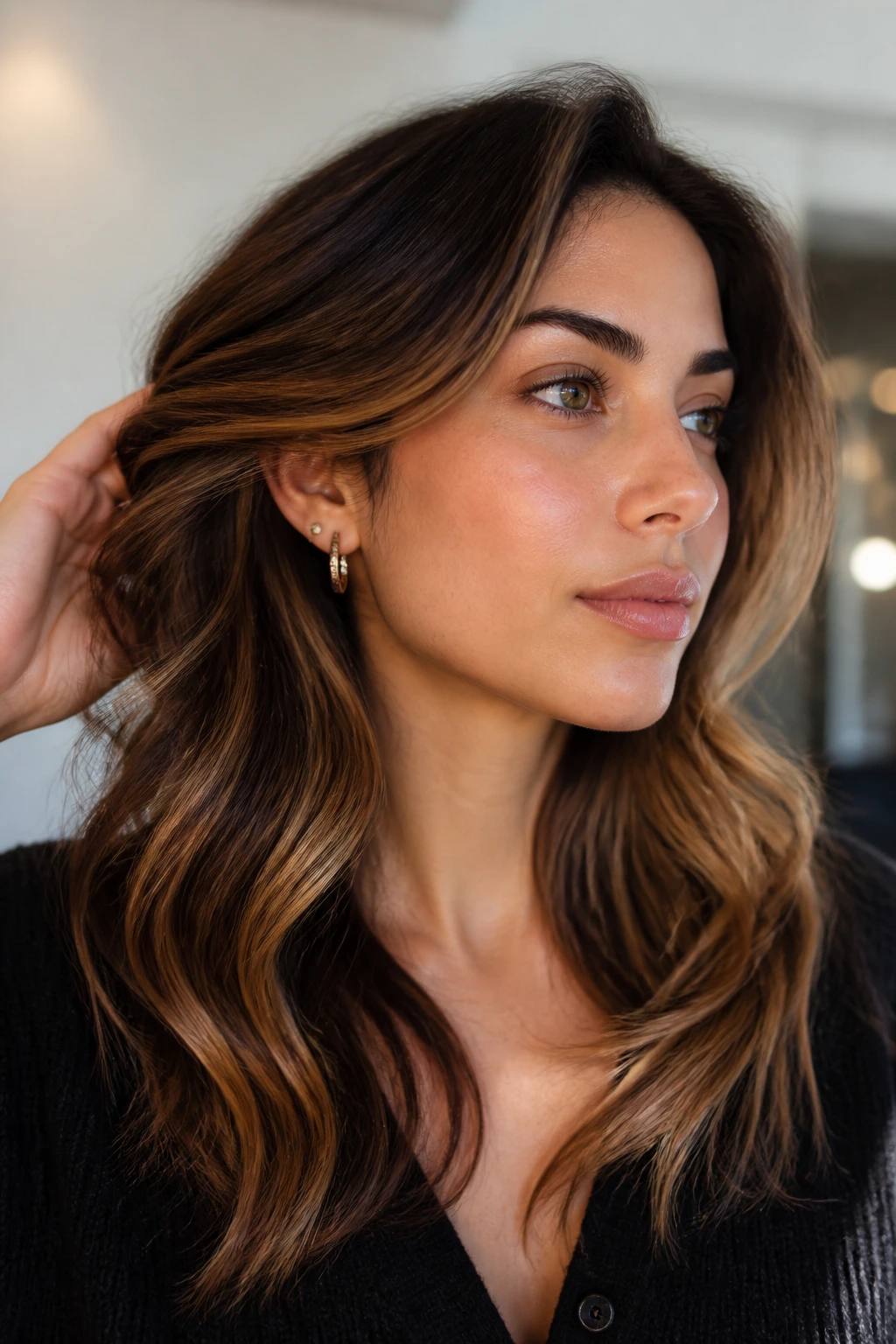 Close-up portrait of a real woman with honeyed bronze foilayage in hair
